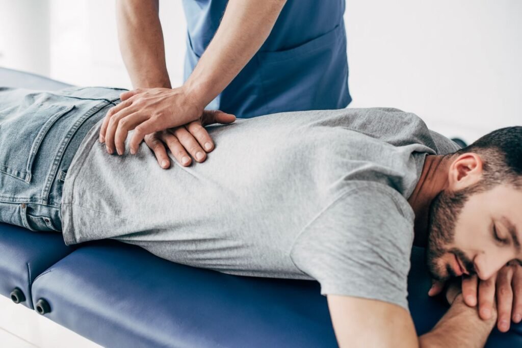 Sports massage therapist providing back pain treatment in Ilkeston